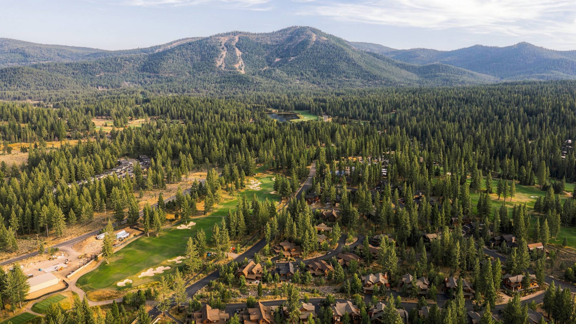 Aerial photograph over a mountain golf community, by The Visaro